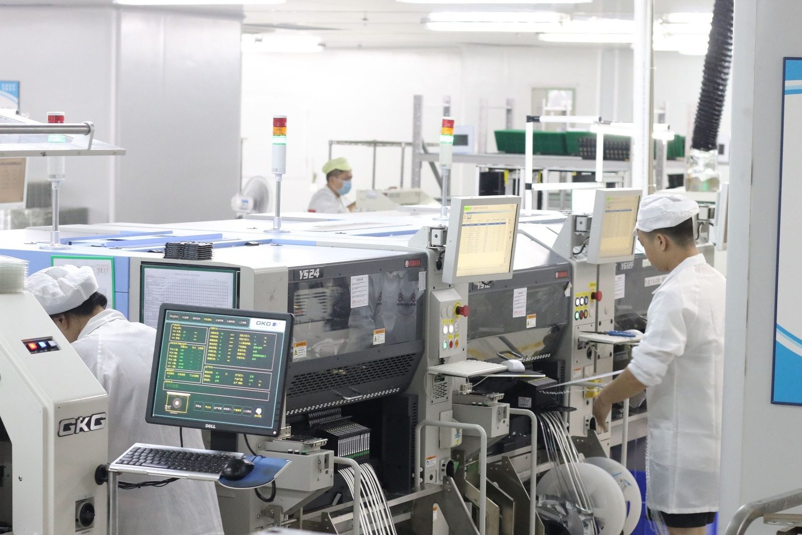 Operators at an SMT line inside the plant