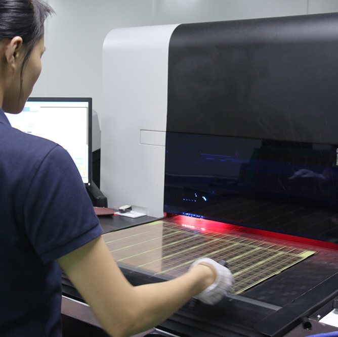 An operator running electrical test on a finished circuit board